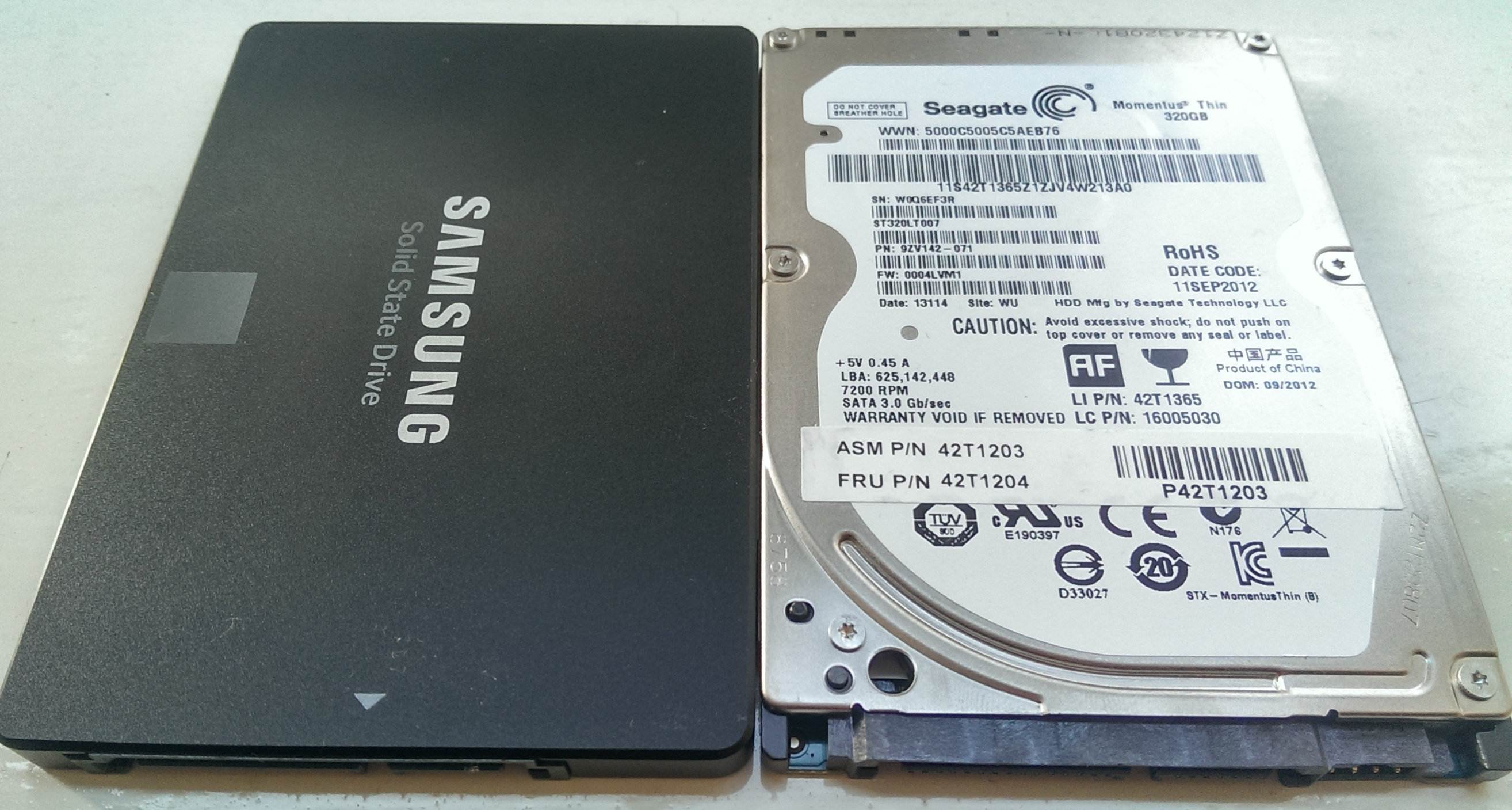 The old 320 GB hard drive, alongside the new Samsung 850 EVO solid-state drive.